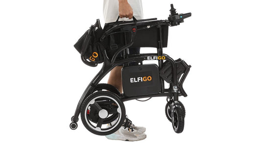 Lightweight foldable electric wheelchair being carried on one hand